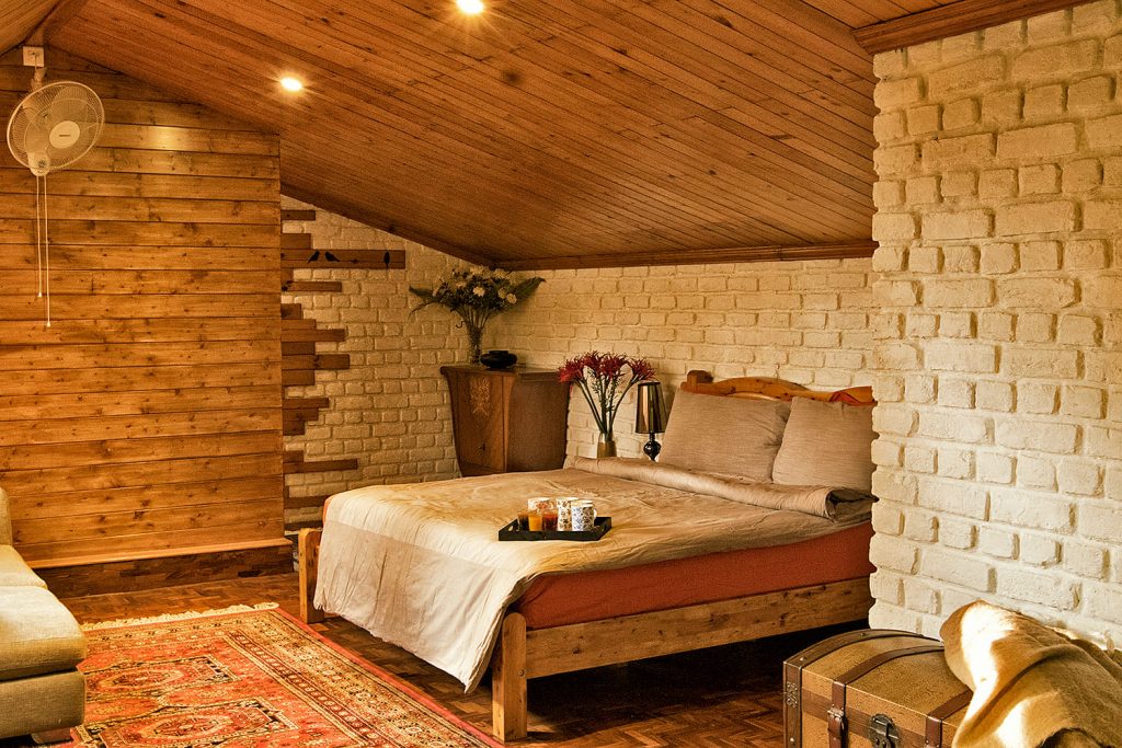 Brick walls, double bed, wooden roof and flooring