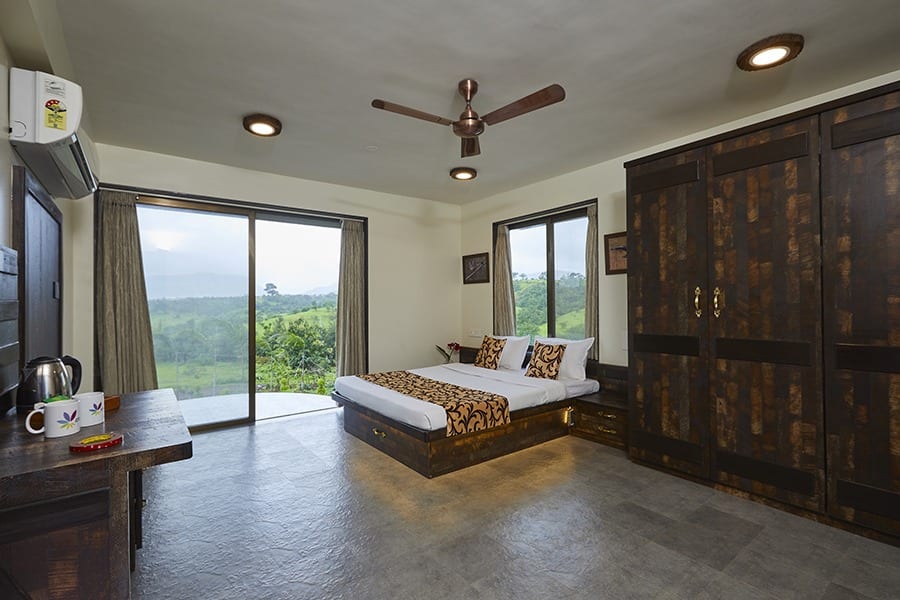 Spacious bedroom with double bed, wardrobe, tall windows, lawn-facing, pet friendly