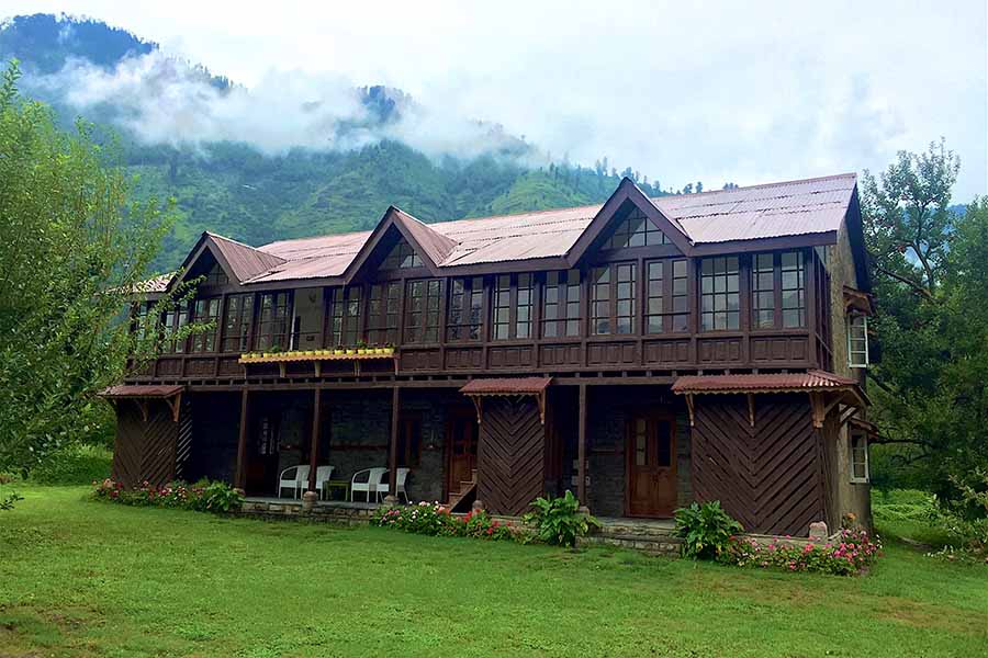 Two storey villa in Manali, dark brown wodden boutique structure