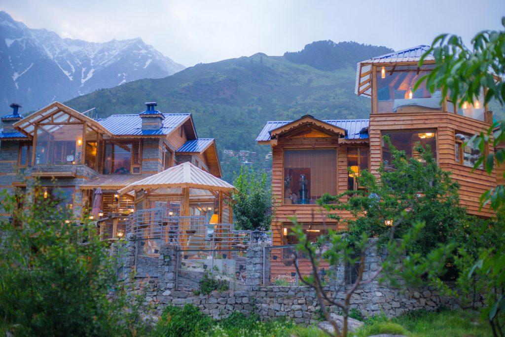 Multistorey villa in Manali, tall windows facing hills and lawn
