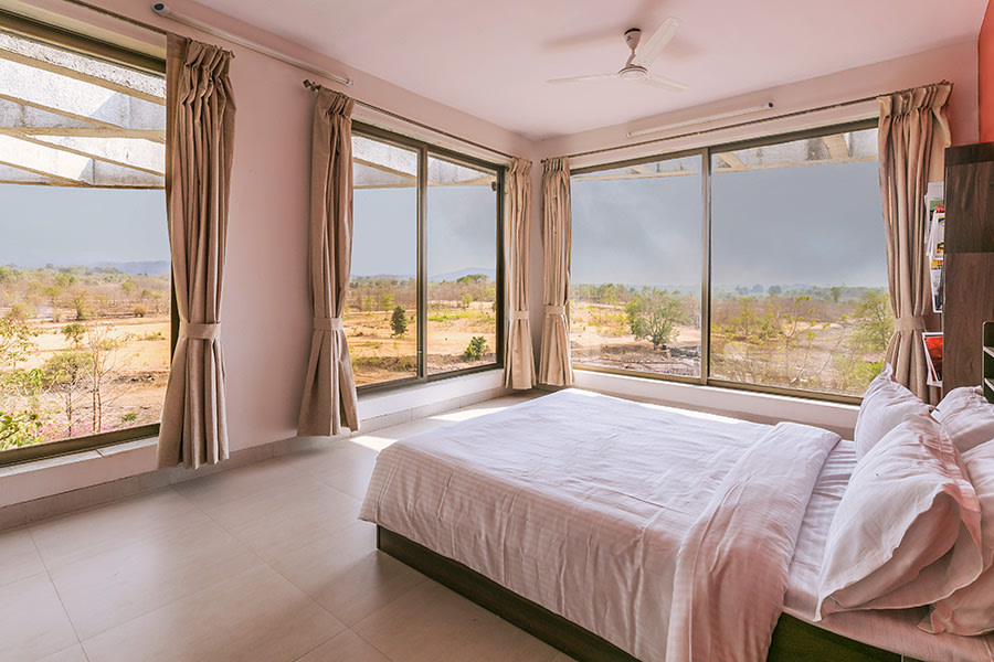 Spacious bedroom, tall windows facing lawn