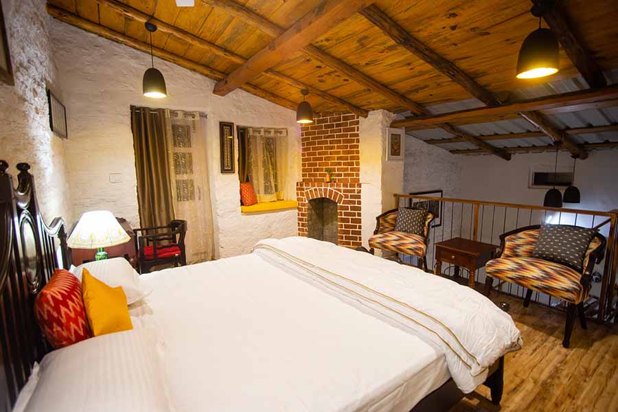 Comfortable wooden interiors bedroom with fireplace