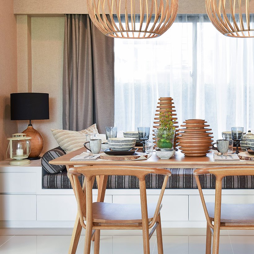 The dining room design whole made up of wood and big wooden hanging lights where the dining table attached to the bed from one side looks like indian dining room design pictures