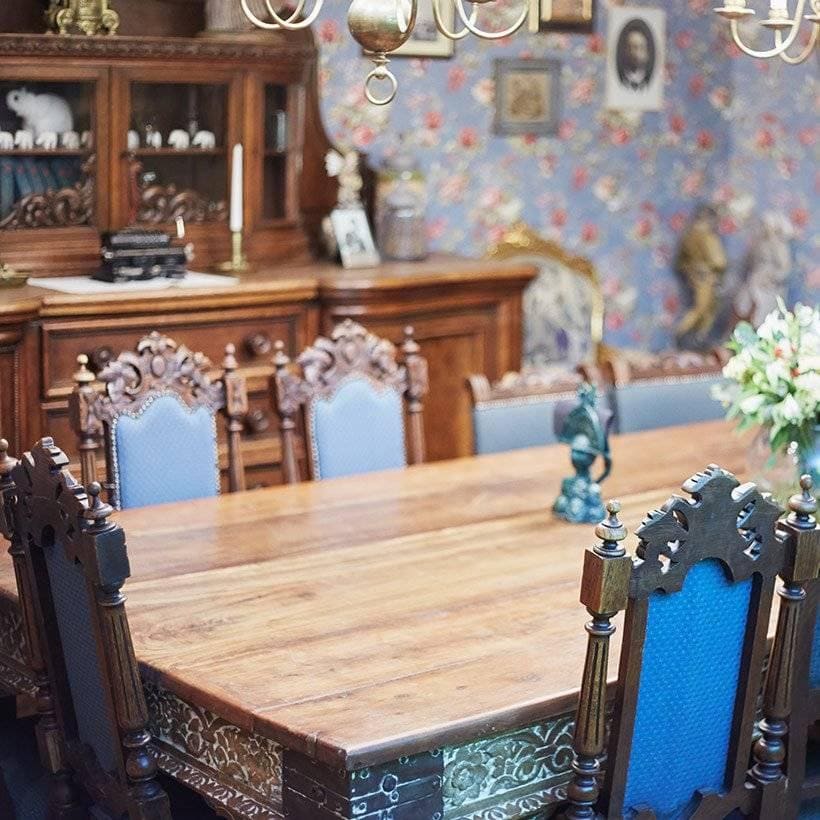 A dining room with a look and royal feel and showcase design for dining room and a sidewall with floral pattern