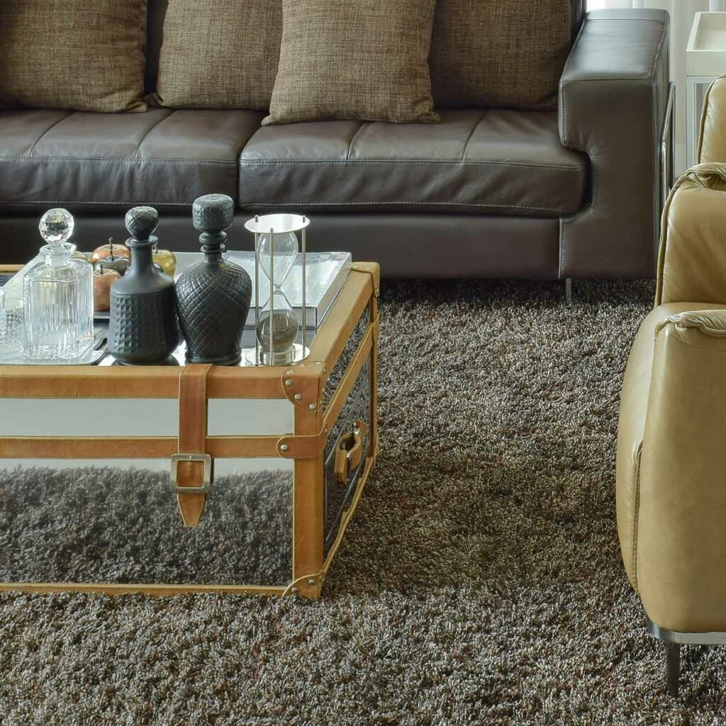 Leather arm chairs with glass table