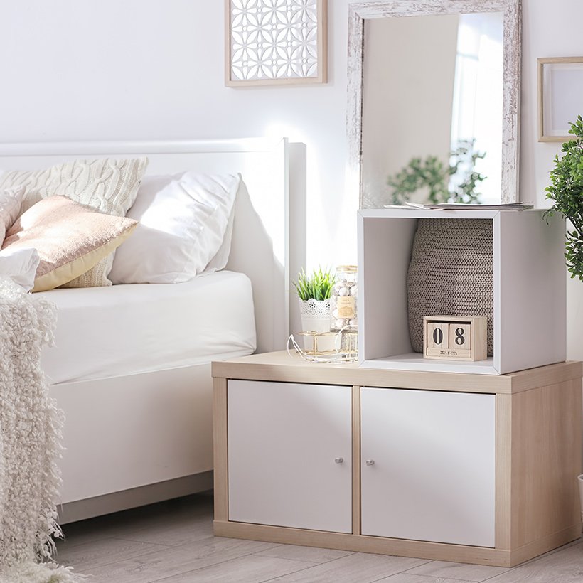 Space maximisation for small bedroom design with a white side cabinet keeps a bedroom clutter free