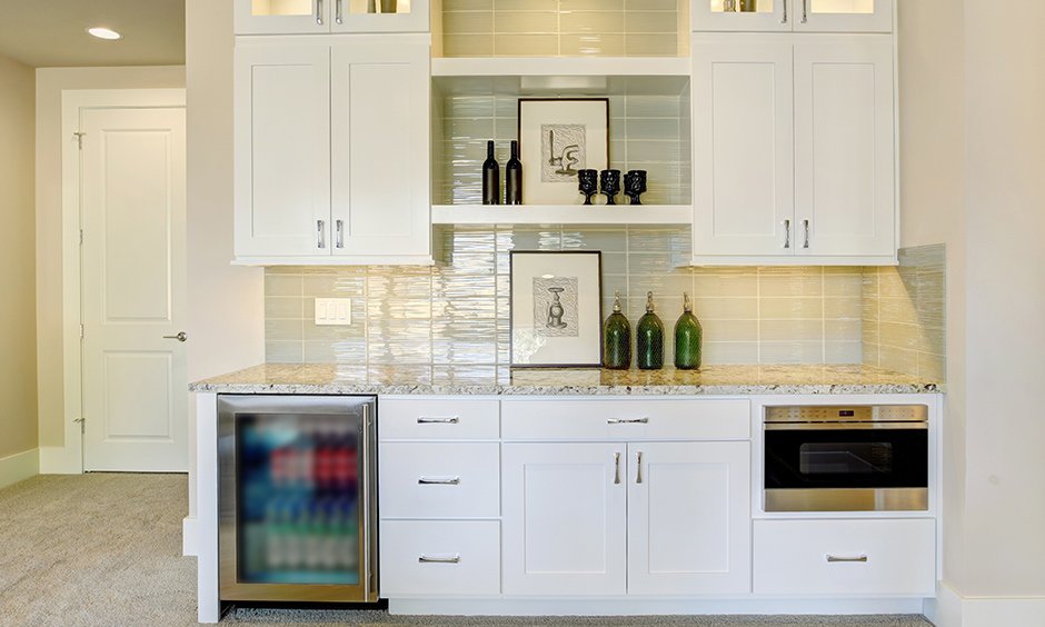 Home bar cabinet fits in well in a minimalistic styled kitchen as it doesn't take too much space.