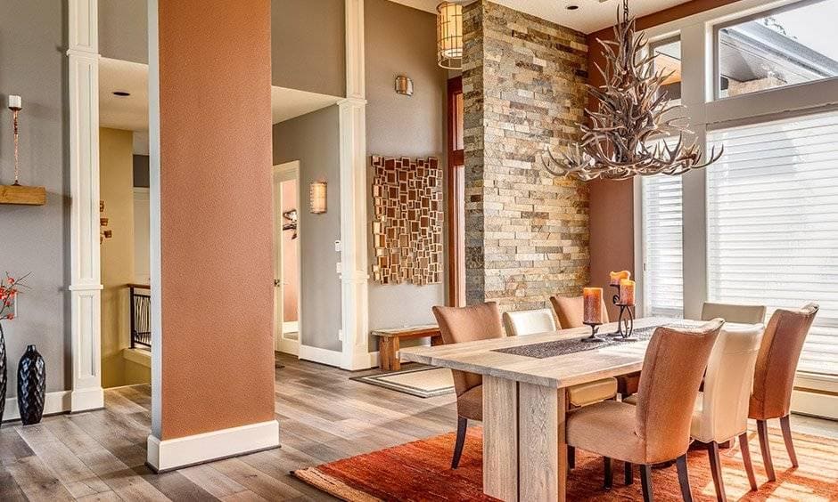 Brick dining wall decor brings in a rustic touch to the space and a feeling of natural outdoors.
