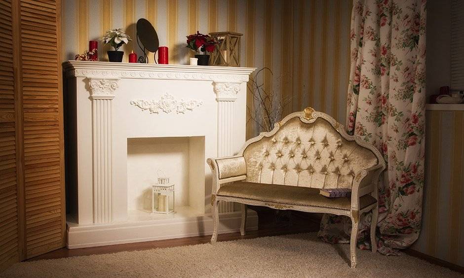 Cosy little reading nook in the house with a modern fireplace is made perfect with the addition of striped golden wallpaper