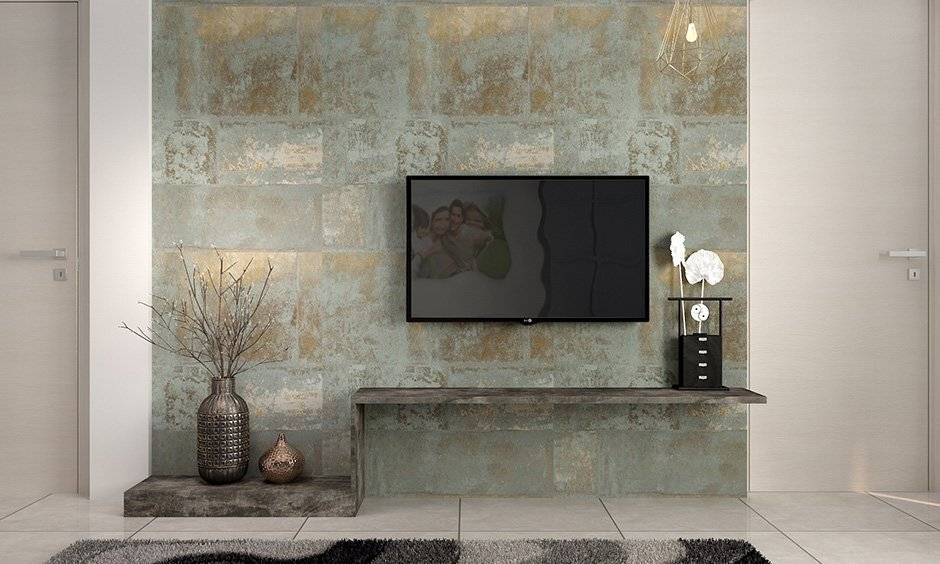 The subtle blue and gold wallpaper manage to add glamour to space and a perfect backdrop for this TV unit in the living room