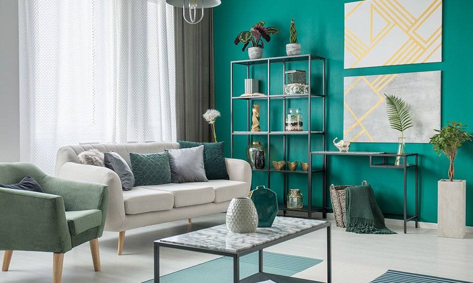 Emerald green living room accessories, indoor plants work as mesmerizing accessories & grants feel-good vibes.