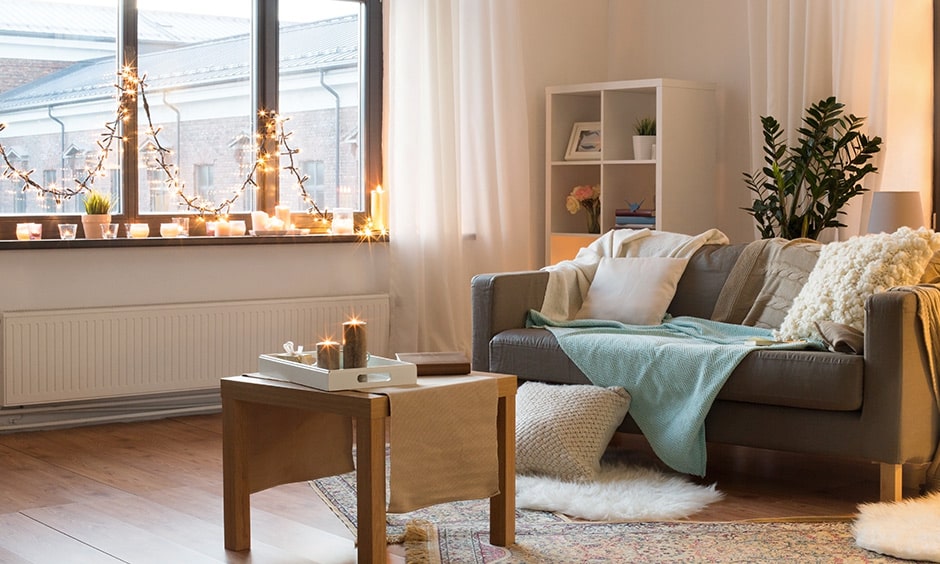 Monsoon home decor in living room with scented candles and fairy lights