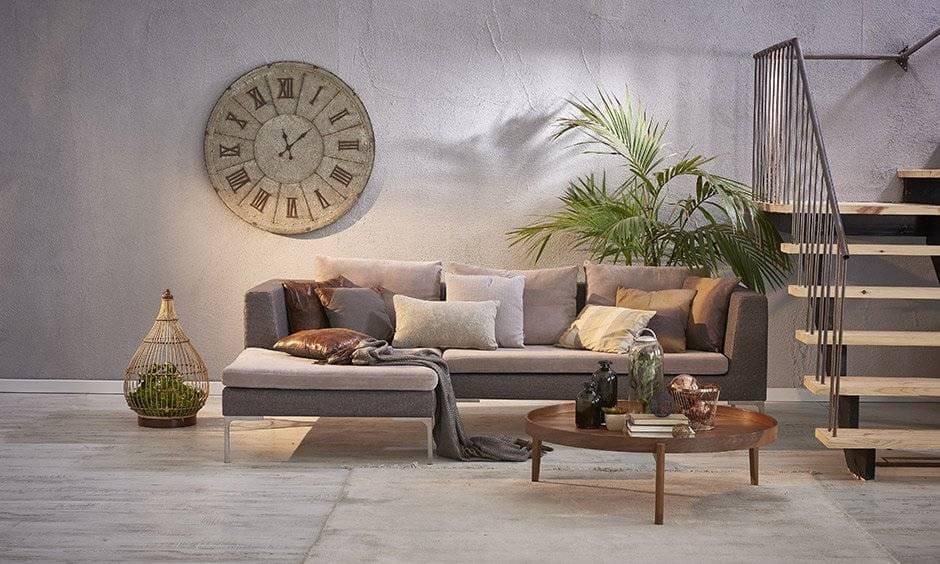 Modern vintage house with a large antique clock in roman numerals adds character to this living room.