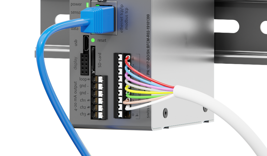 Rheonics SME transmitter electronics showing color-coded sensor cable connections and terminal block wiring on a DIN rail mount.