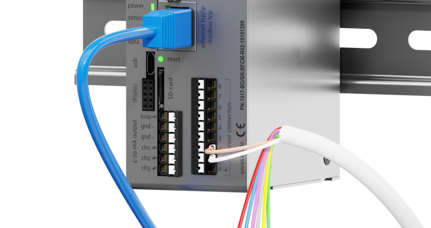 Color-coded sensor wires being connected to the Rheonics SME transmitter terminal block mounted on a DIN rail.